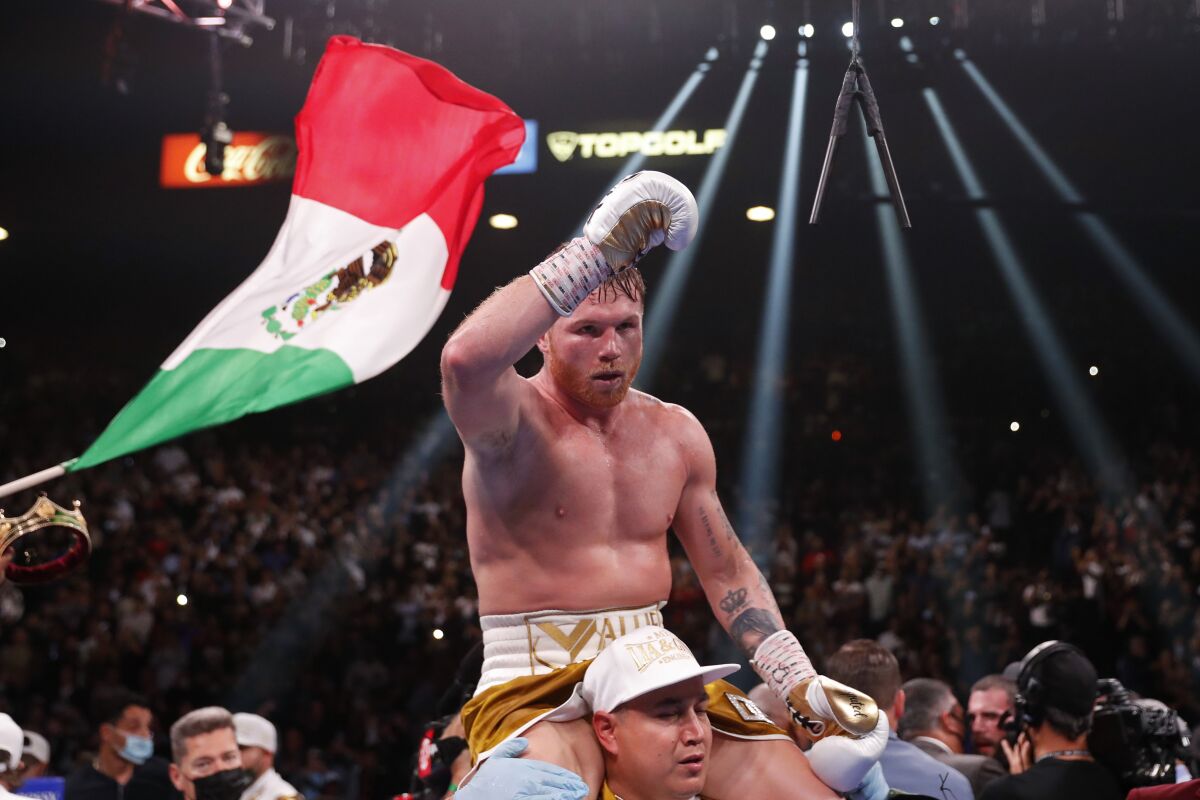 Canelo Alvarez, of Mexico, celebrates after defeating Caleb Plant by TKO in a super middleweight 