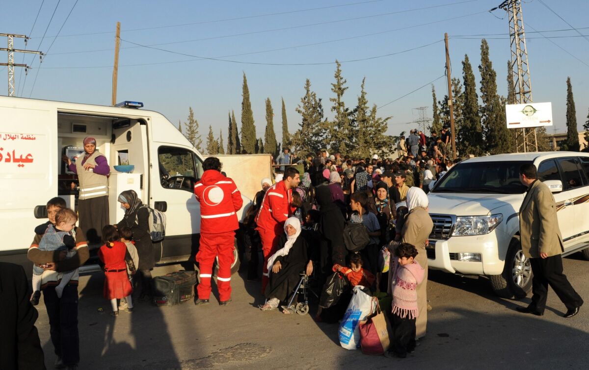 Women and children arrive to be evacuated from a Damascus suburb by the Syrian Arab Red Crescent.