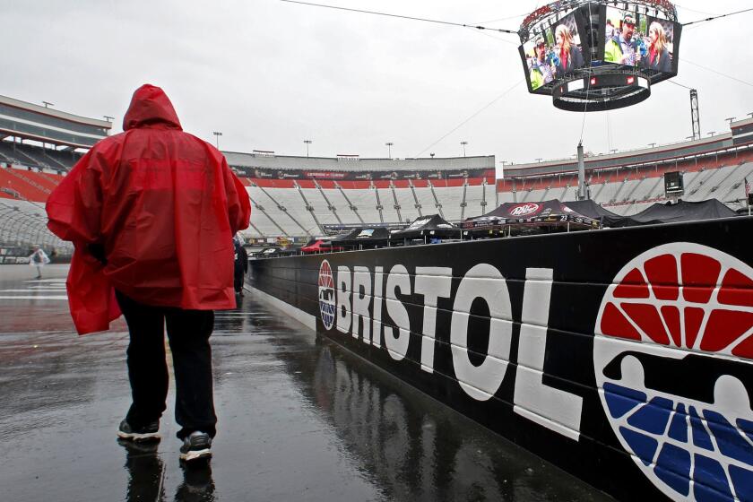 A fan walks along the wall at Bristol Motor Speedway before a NASCAR Monster Energy NASCAR Cup Series auto race, Sunday, April 23, 2017, in Bristol, Tenn. (AP Photo/Wade Payne)