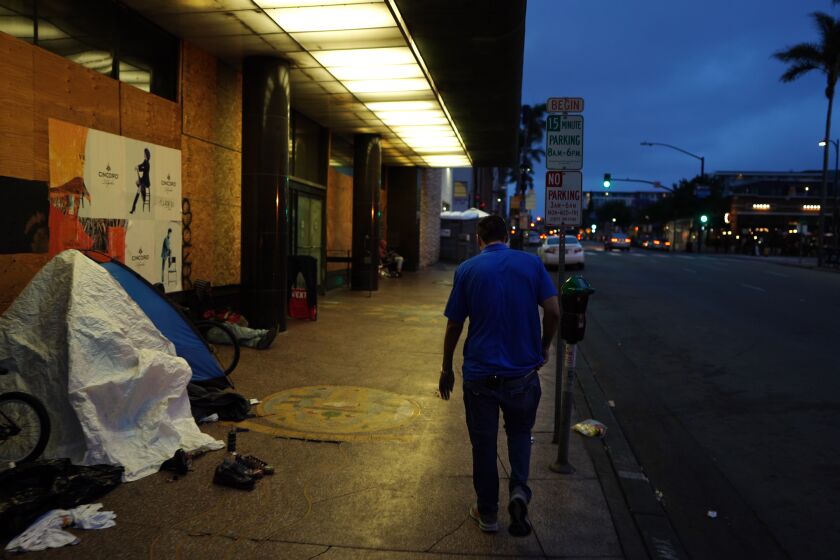 San Diego, CA - April 27: On this evening Adrian Arias walked the downtown area on Wednesday, April 27, 2022 in San Diego, CA., to show where he used to sleep and pray when he was living on the streets. “I used to pray from 6 a.m. to 8 p.m. every day,” he said, describing how he would say the Rosary over and over while kneeling on the sidewalk. “I was talking to myself, walking around, not taking showers for a month, eating from garbage cans. I was really down and out. I was really a hopeless case.” (Nelvin C. Cepeda / The San Diego Union-Tribune)
