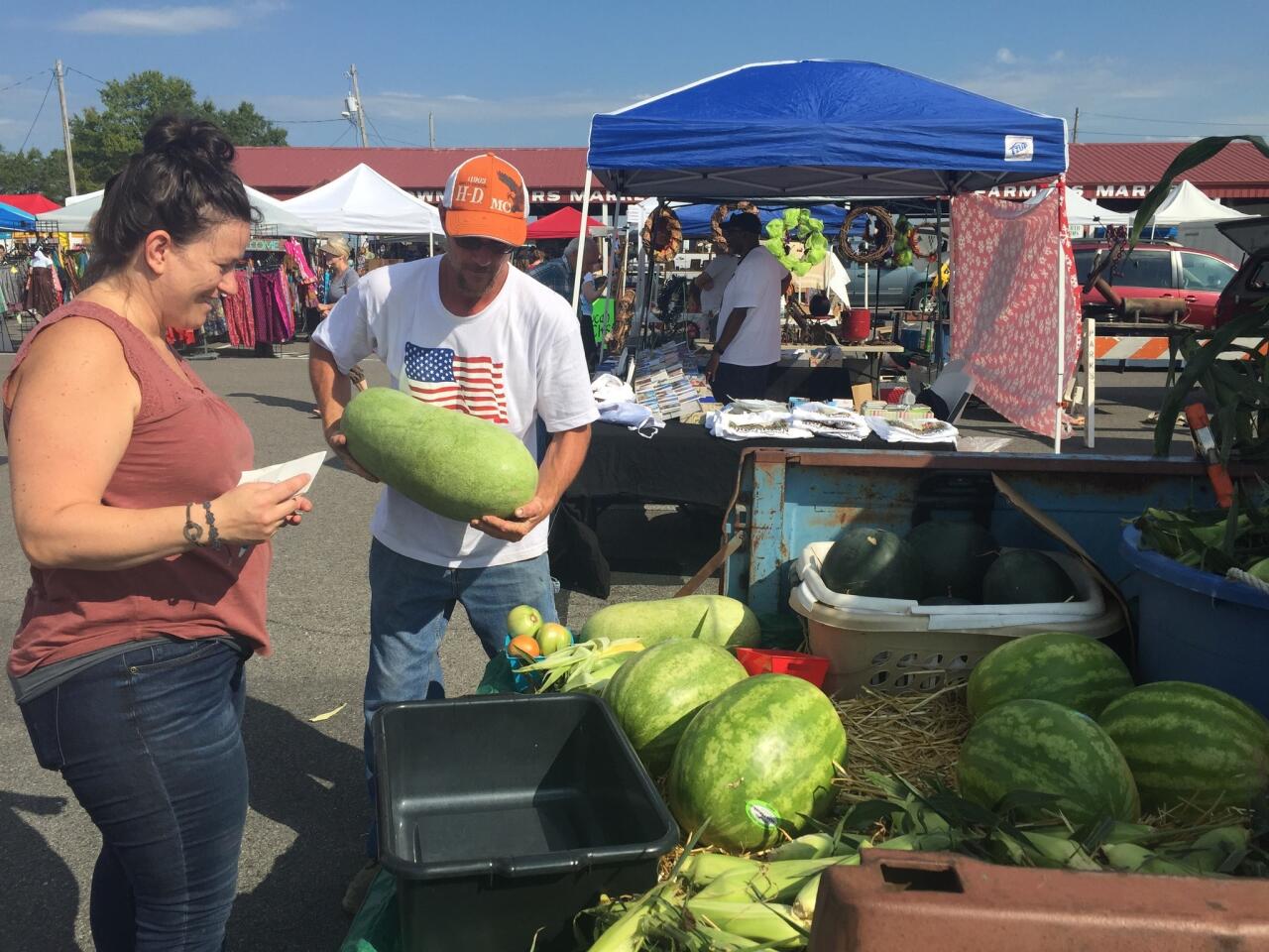 Chef Sara Bradley shops for melons at the Paducah farmers market in the summer of 2017. She said the market can have four or five states represented by vendors from the surrounding area.