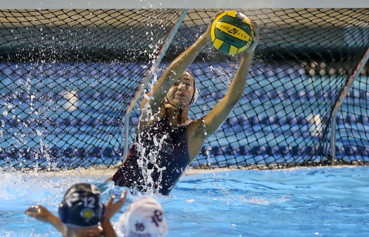 Laguna Beach goalkeeper Lauren Schneider makes a crucial save against Newport Harbor during the semifinals of the CIF Southern Section Division 1 playoffs at Irvine’s Woollett Aquatics Center on Wednesday.