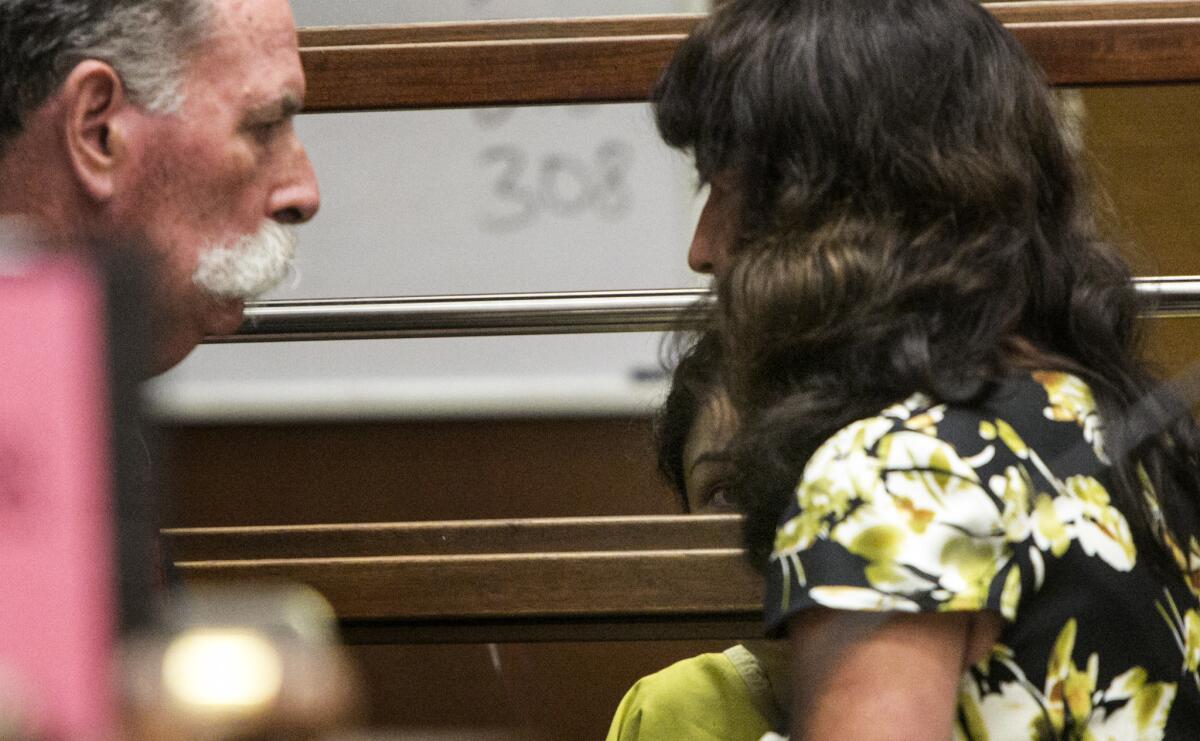 With her back to the court, Leyla Ors consults with her German interpreter during her arraignment.