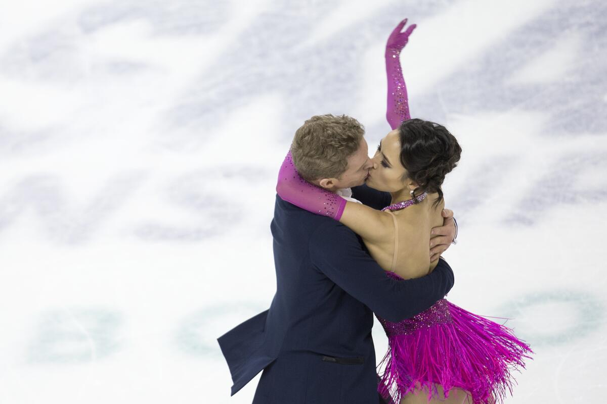 Evan Bates and Madison Chock kiss during their rhythm dance routine Jan. 24, 2020, at the U.S. Figure Skating Championships.