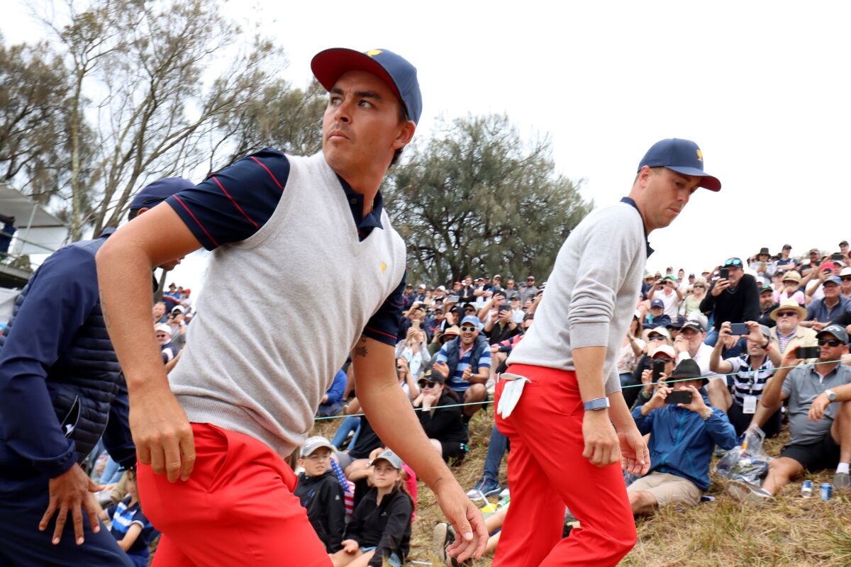 Rickie Fowler and Justin Thomas of the United States team walk on the fourth hole during Saturday's four-ball matches on Day 3 of the Presidents Cup at Royal Melbourne Golf Course on Dec. 14.