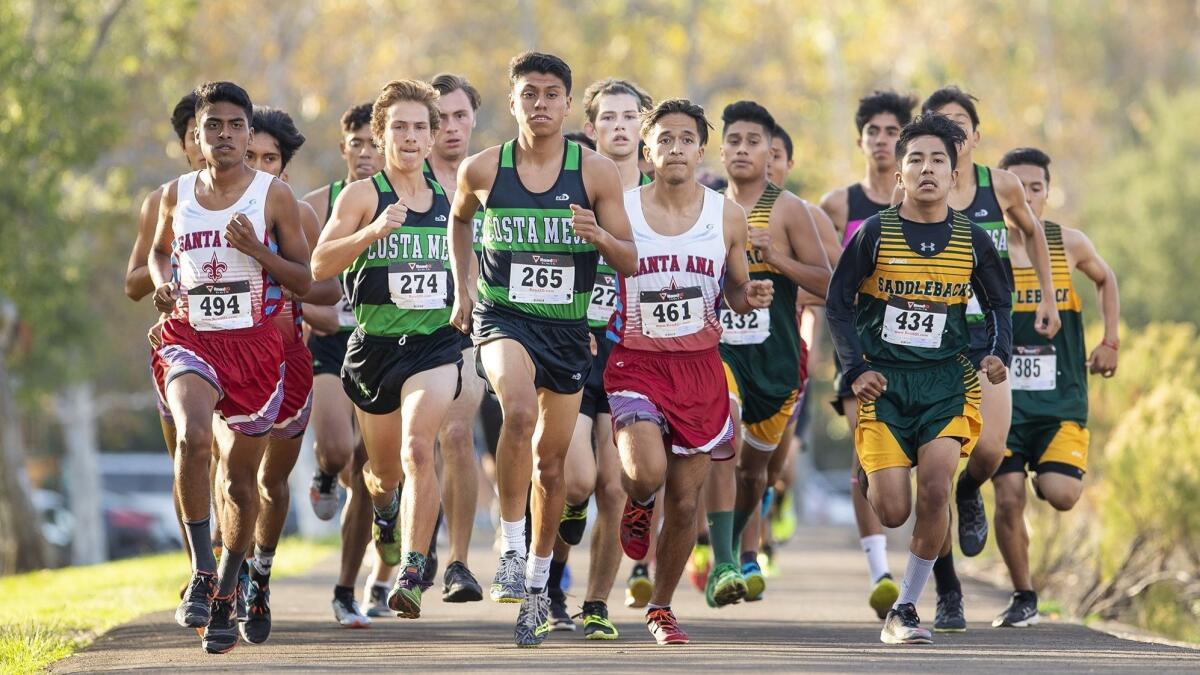 Costa Mesa High's Riley Mitchell, left, and Kevin Cortez lead the pack at the start of the Orange Coast League boys' cross-country finals at Irvine Regional Park in Orange on Monday.