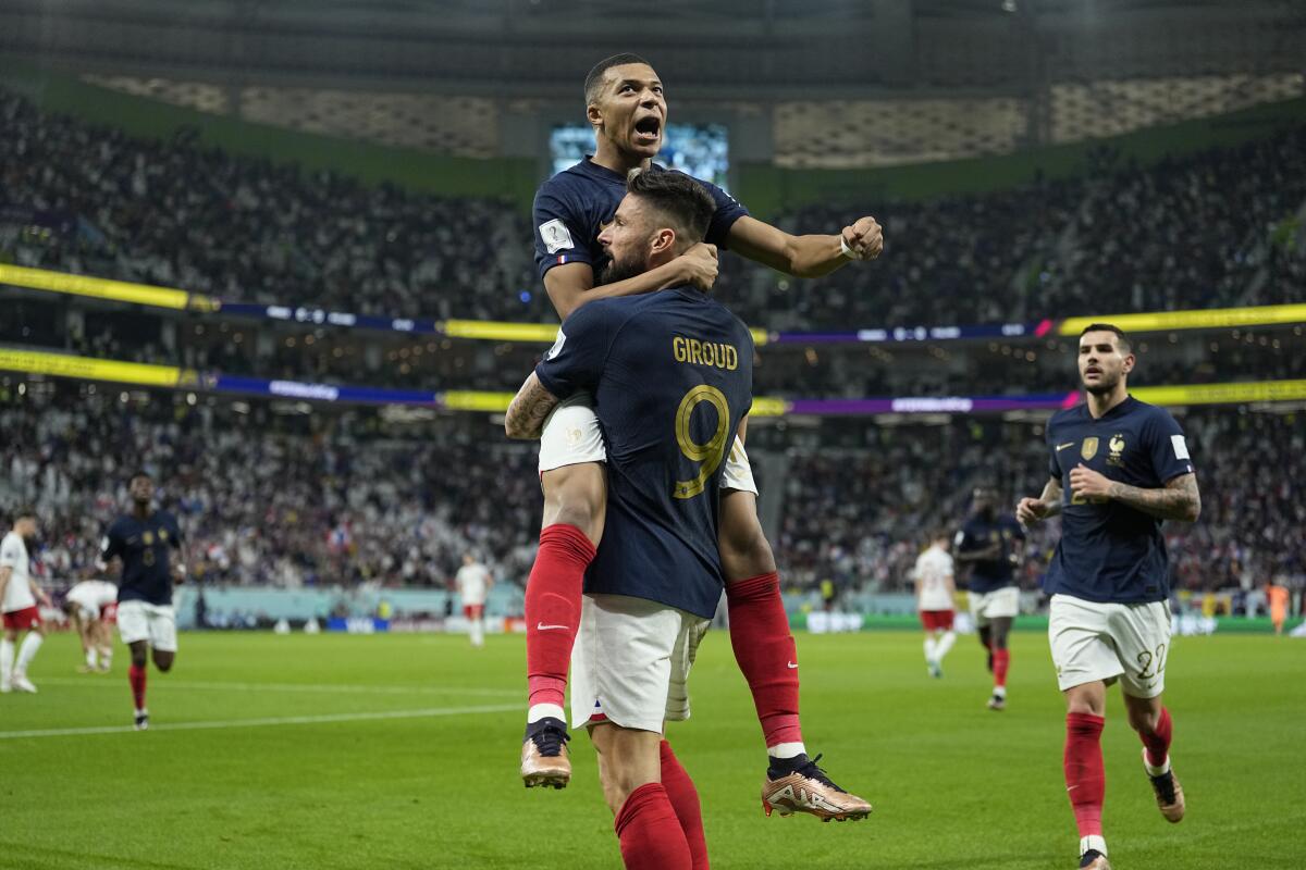France's Olivier Giroud celebrates with Kylian Mbappe after scoring during the World Cup.