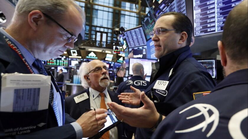 Specialist Anthony Matesic, right, works with traders on the floor of the New York Stock Exchange on Friday.