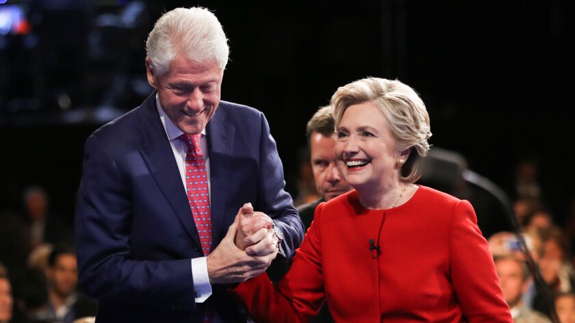Hillary Clinton walks off the stage with her husband former President Bill Clinton after the presidential debate with Donald Trump at Hofstra University in Hempstead, N.Y. on Sept. 26.