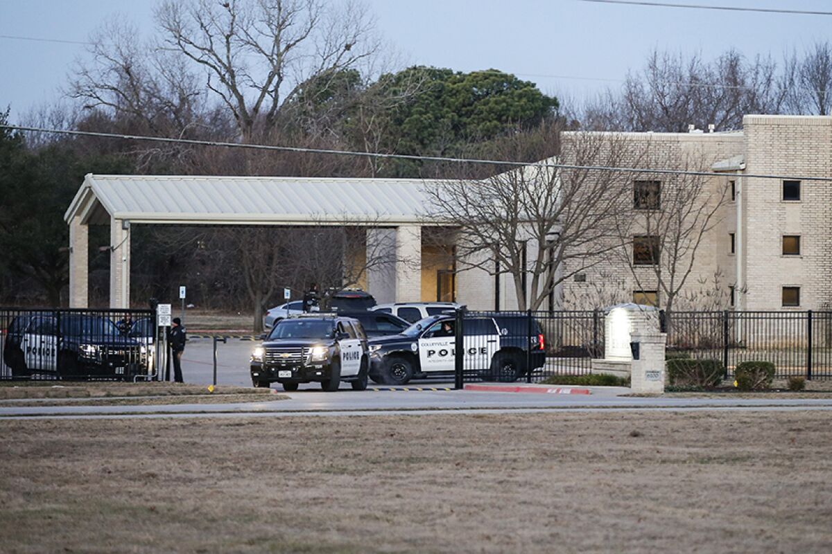 Police cars and officers outside a synagogue