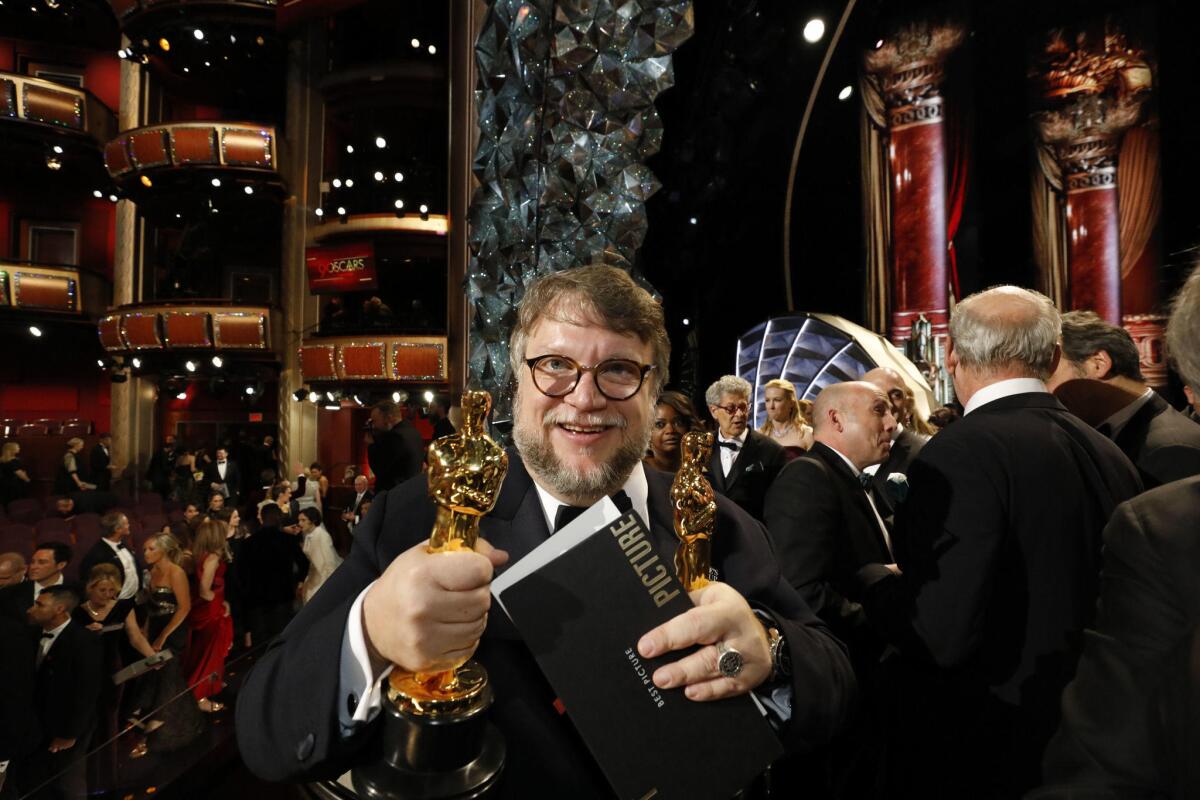 "The Shape of Water" director Guillermo del Toro holds one of his Oscars after the 90th Academy Awards.