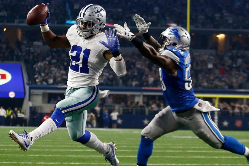 Dallas running back Ezekiel Elliott, left, gets past Detroit linebacker Tahir Whitehead for a touchdown on Dec. 26.