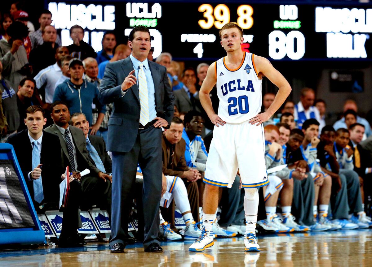 UCLA Coach Steve Alford and son Bryce confer during a game against Oregon at Pauley Pavilion on Feb. 27.
