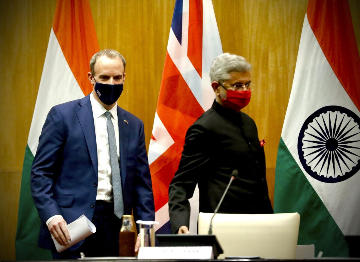 British Foreign Secretary Dominic Raab, left and Indian Minister of External Affairs Subrahmanyam Jaishankar arrive to make joint press statements after their meeting in New Delhi, India, Tuesday, Dec.15, 2020. (AP Photo/Manish Swarup)