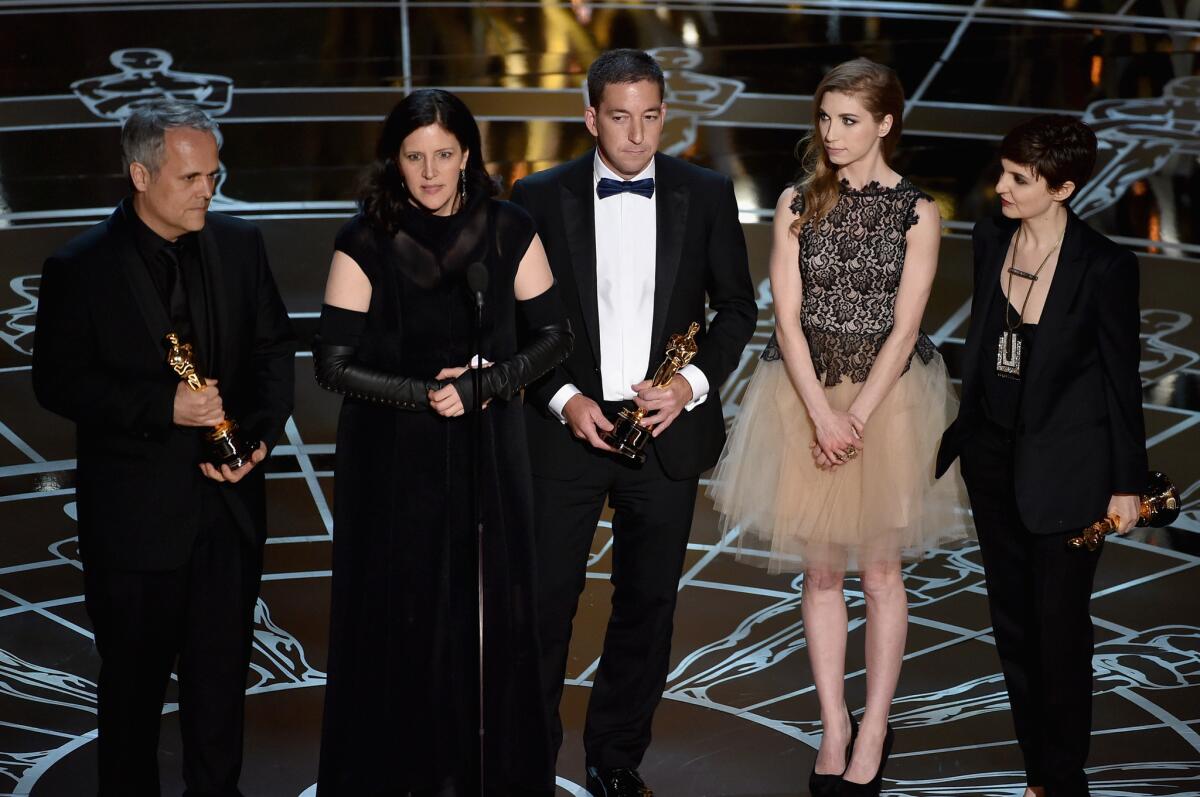 Producer Dirk Wilutzky, director Laura Poitras, journalist Glenn Greenwald, Lindsay Mills and producer Mathilde Bonnefoy accept the documentary feature Oscar on Sunday for "CitizenFour" onstage.