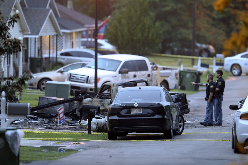 Hattiesburg police surround a burned automobile and a damaged home after a small plane crashed late Tuesday night in Hattiesburg, Miss., Wednesday May 5, 2021. Emergency officials in Mississippi say a few people were killed when the small plane crashed into a home. (Chuck Cook /The Advocate via AP)