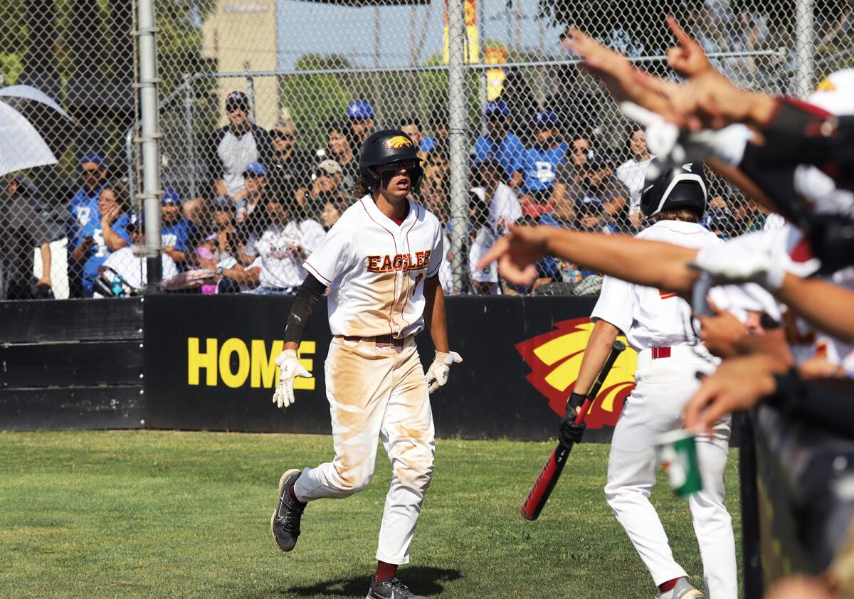 Estancia's Jack Moyer (8) scores in the first inning against Baldwin Park during the Division V regional final.