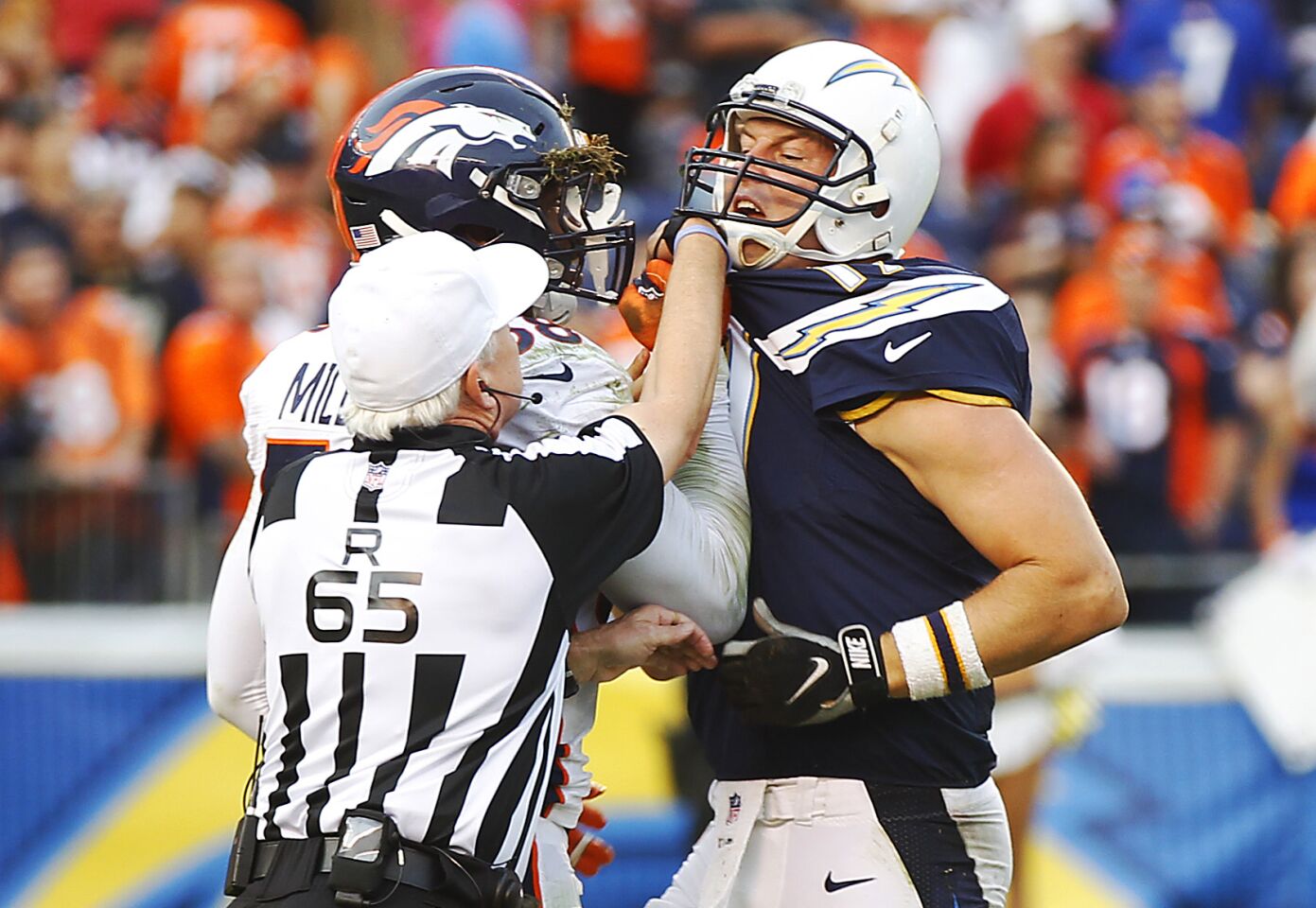 Chargers Philip Rivers and Broncos Von Miller get into it during the final moments of the 4th quarter on Dec. 6, 2015.