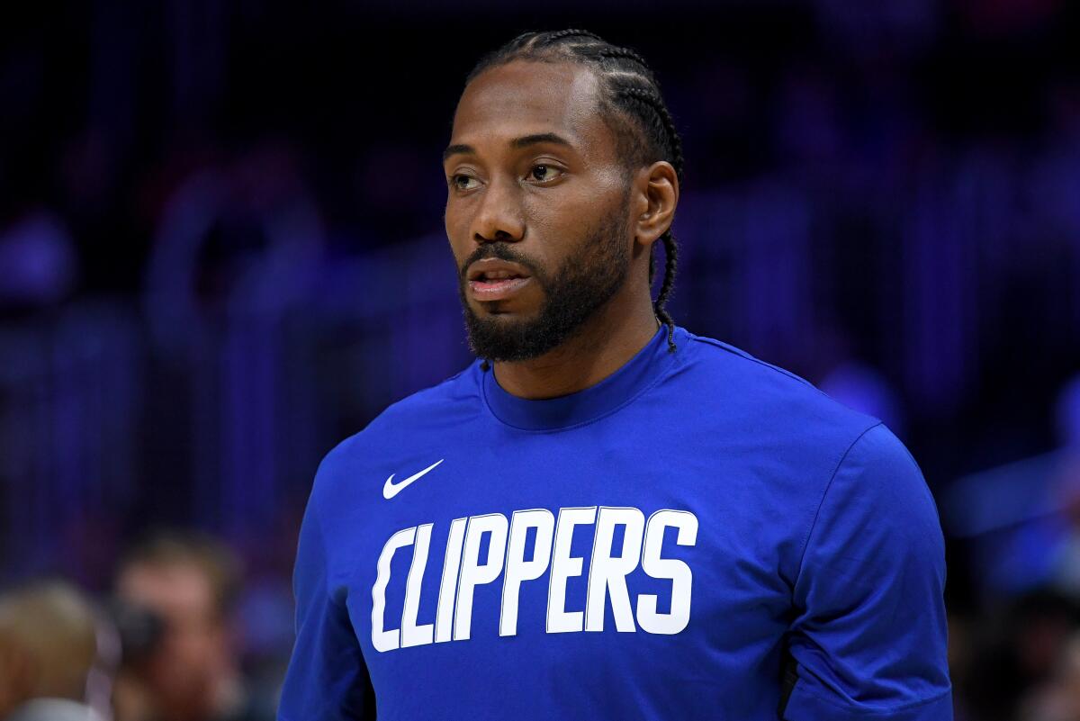 Clippers star Kawhi Leonard warms up before a game against the Denver Nuggets on Oct. 10.