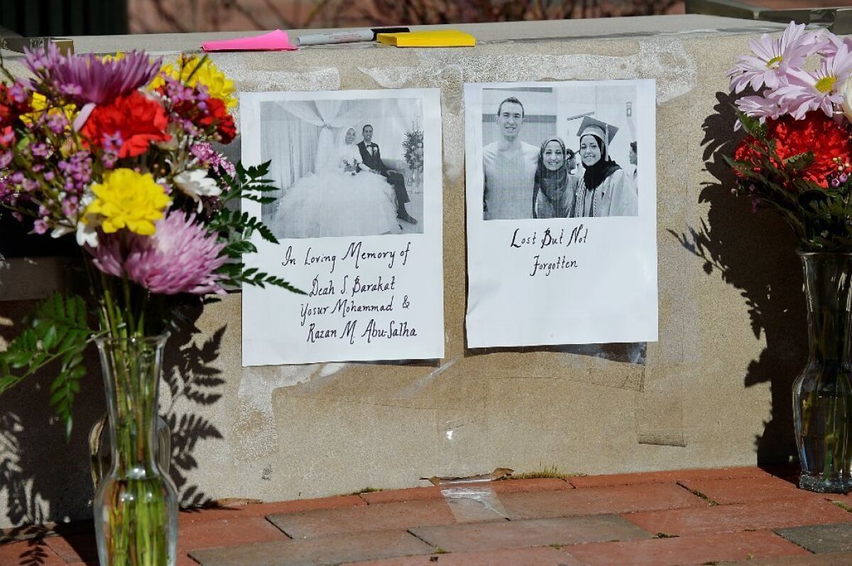 Flowers at a tribute outside the University of North Carolina School of Dentistry for dentistry student Deah Shaddy Barakat, his new wife, Yusor Mohammad, and her sister Razan Mohammad Abu-Salha in Chapel Hill, N.C.