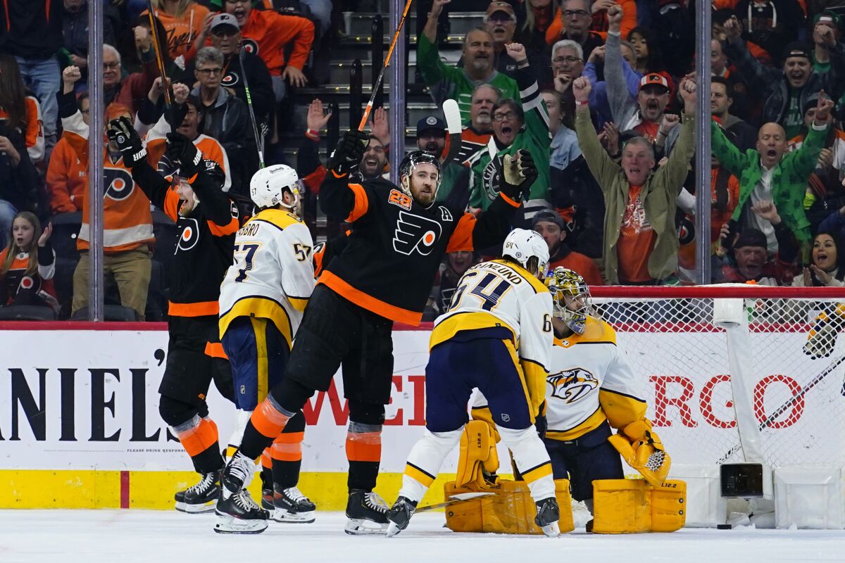 Philadelphia Flyers' Kevin Hayes, center, reacts after scoring a goal during the third period of an NHL hockey game against the Nashville Predators, Thursday, March 17, 2022, in Philadelphia. (AP Photo/Matt Slocum)