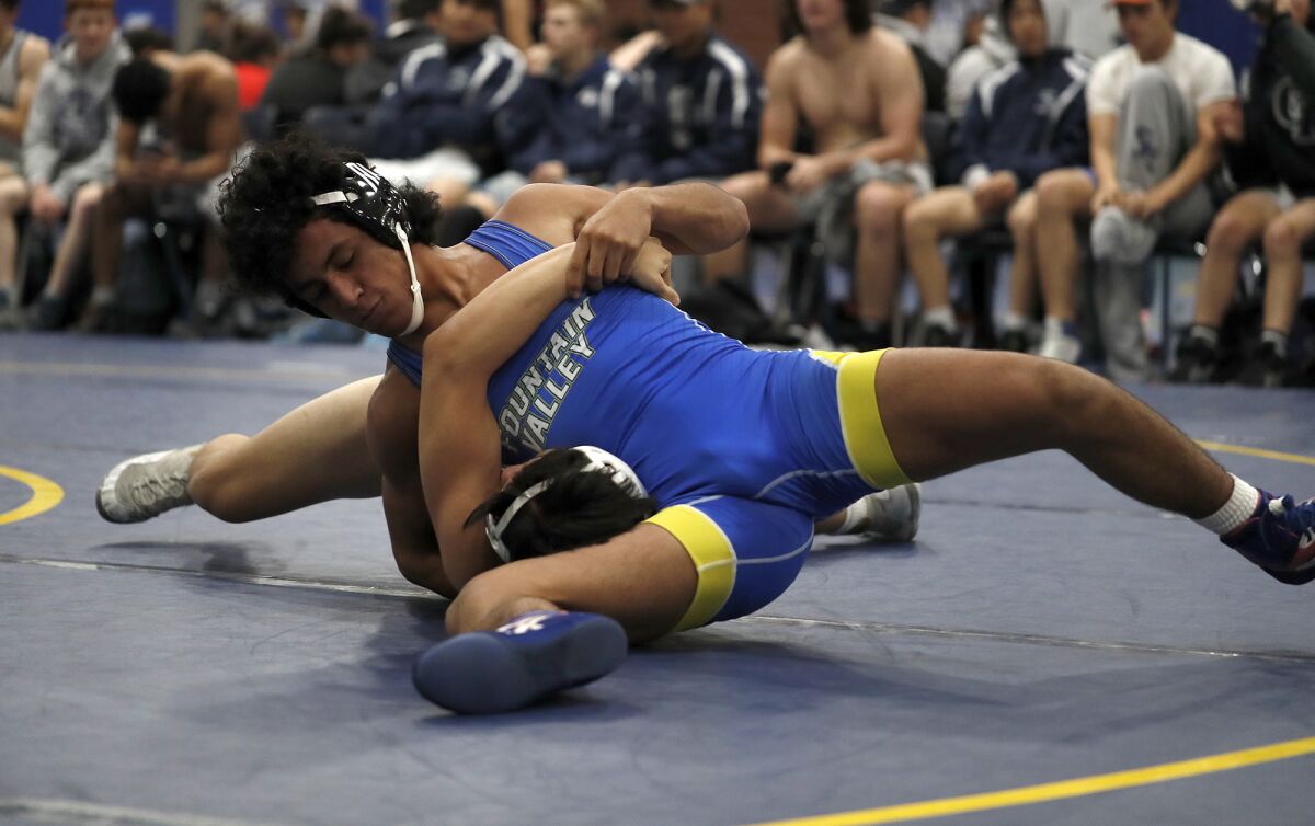 Fountain Valley's Luis Ramirez competes against Chino Hills in a 145-pound match during the first round of the CIF Southern Section dual-meet wrestling championships at Fountain Valley High on Saturday.