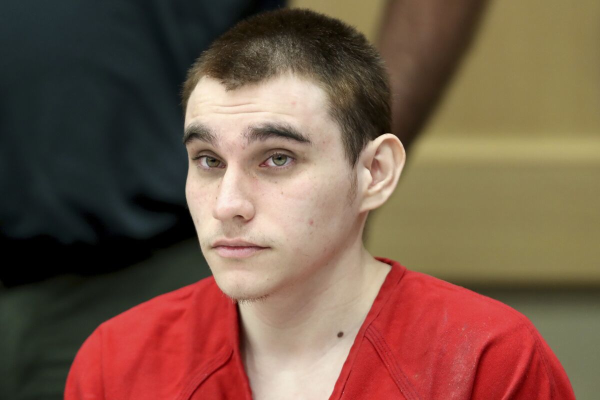 FILE - In this Dec. 10, 2019 Nikolas Cruz appears at a hearing in Fort Lauderdale Fla. The death penalty trial of Cruz, the man charged with killing 17 people at a Florida high school is off indefinitely because of restrictions related to the coronavirus. Broward Circuit Judge Elizabeth Scherer refused Tuesday, Aug. 17, 2021, to close pretrial hearings to the media and public in the case of the Cruz, accused of killing 17 people in a 2018 high school mass shooting. Cruz's lawyers claim that intense media coverage jeopardizes his right to a fair trial. (Amy Beth Bennett/South Florida Sun-Sentinel via AP, Pool, File)
