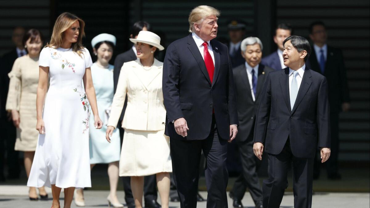 President Trump and First Lady Melania Trump are escorted by Japan's Emperor Naruhito and Empress Masako during a welcome ceremony on Monday at the Imperial Palace in Tokyo.