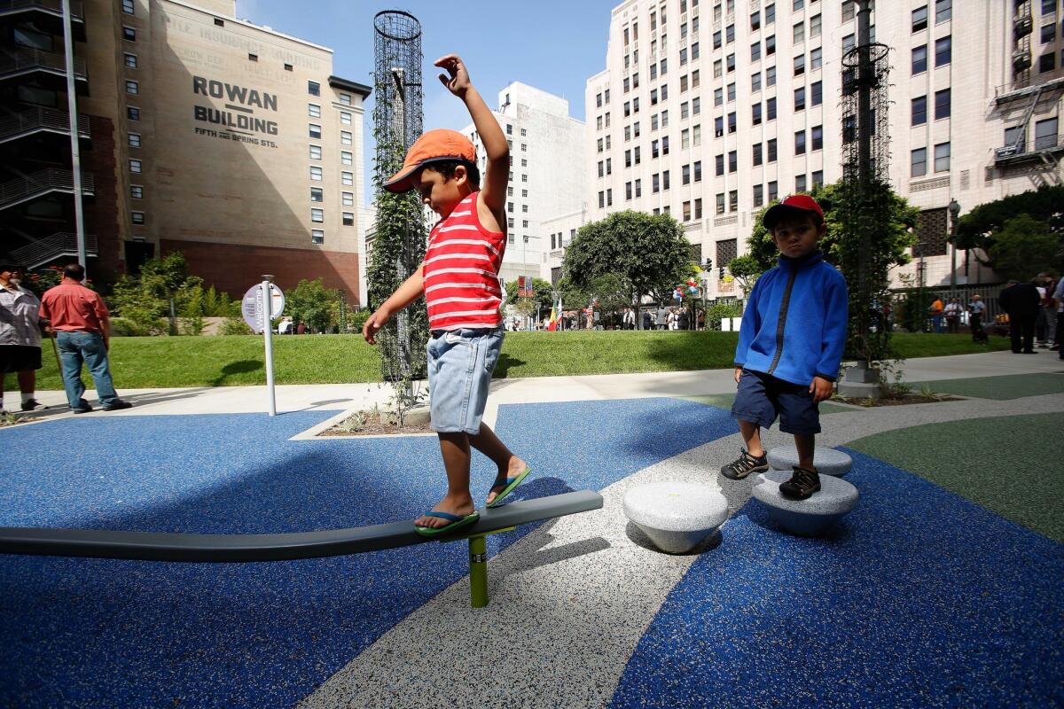 Matteo Walters, 4, left, keeps his balance while playing in the newly opened South Spring Park in Downtown Los Angeles. At right is his brother Angelo, 3.