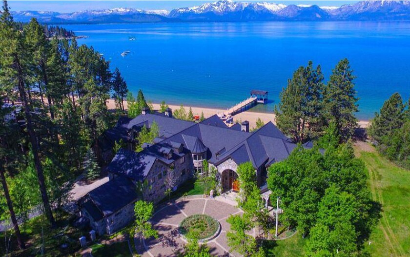 The lakefront estate holds two homes that combine for more than 18,000 square feet.
