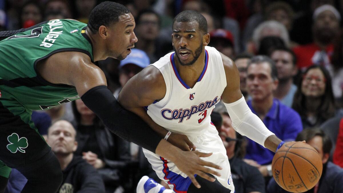 Boston Celtics forward Jared Sullinger, left, tries to steal the ball away from Clippers point guard Chris Paul during the Clippers' 102-93 win Monday.