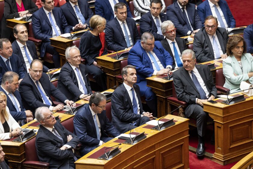 Greece's former Prime Minister and leader of New Democracy party Kyriakos Mitsotakis, third right front row, attends a swearing in ceremony at the parliament in Athens, Greece, Sunday, May 28, 2023. Newly elected Greek lawmakers were sworn in Sunday, but the Parliament elected on May 21 could be dissolved as early as Monday and a new election campaign start for another election, on June 25. (AP Photo/Yorgos Karahalis)