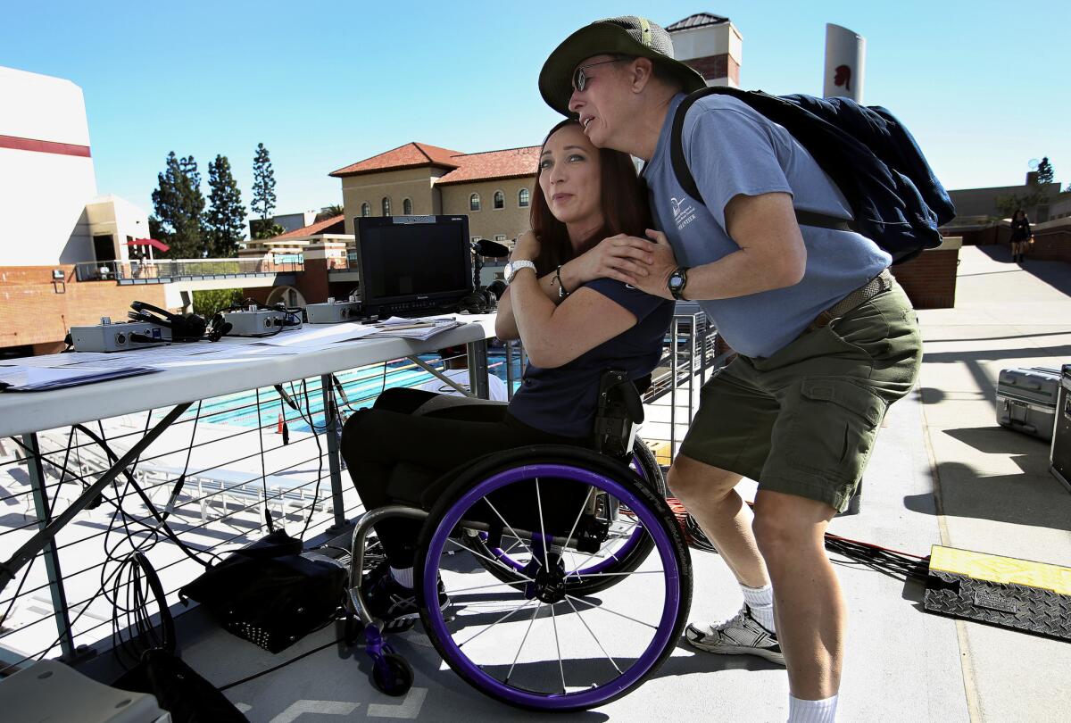 Six-time Olympic gold medalist Amy Van Dyken has kept a positive outlook after suffering a severed spinal cord last June and is an inspiring figure to admirers such as John Lewis, above, who met her at a recent event at USC and became emotional.