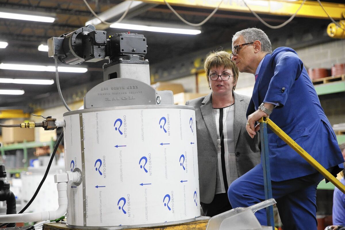 Export-Import Bank chief Fred Hochberg, left, gets a tour of Howe Corp. in Chicago from President Mary Howe in June. The family-owned Chicago small business exports refrigeration equipment with the bank's support.