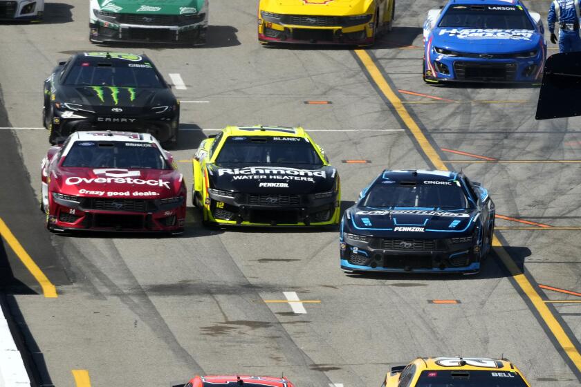 Austin Cindric, right, exits his pit stall as Ryan Blaney, center, and Chase Briscoe, left, follow during a NASCAR Cup Series auto race at World Wide Technology Raceway Sunday, June 2, 2024, in Madison, Ill. (AP Photo/Jeff Roberson)