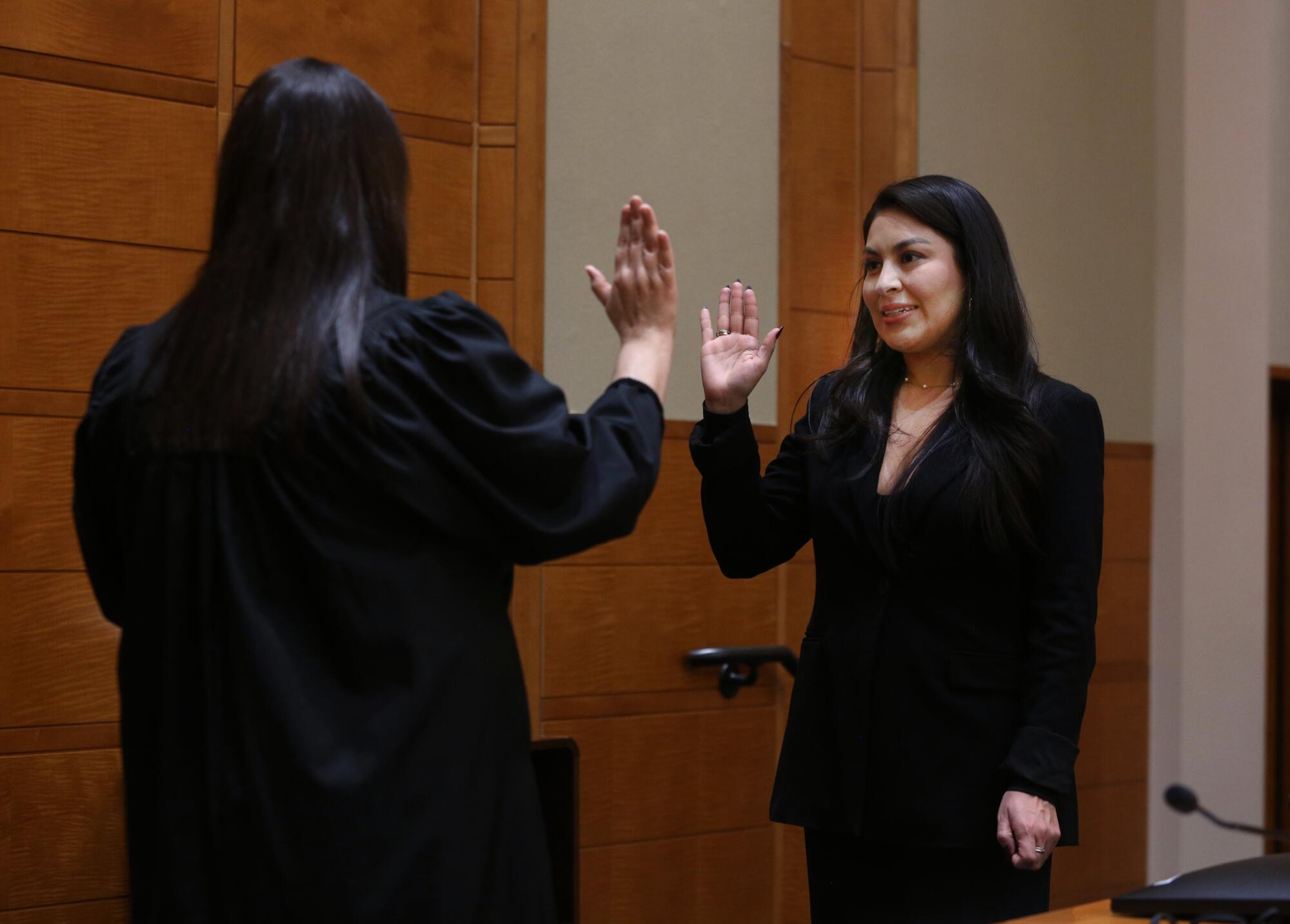 Jessenia Nunez, right, is sworn in at the Robert E. Coyle Federal Courthouse by Ana De Alba