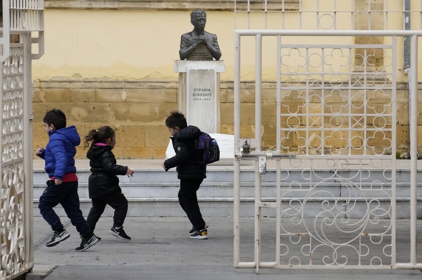 Children play at Faneromeni square at the end of a school day in central capital Nicosia, Cyprus, Wednesday, Jan. 12, 2020. Cyprus will replace compulsory quarantine periods for school children deemed as close contacts to classmates who tested positive for COVID-19 with daily rapid and self tests over five days in an effort to keep them in school. (AP Photo/Petros Karadjias)