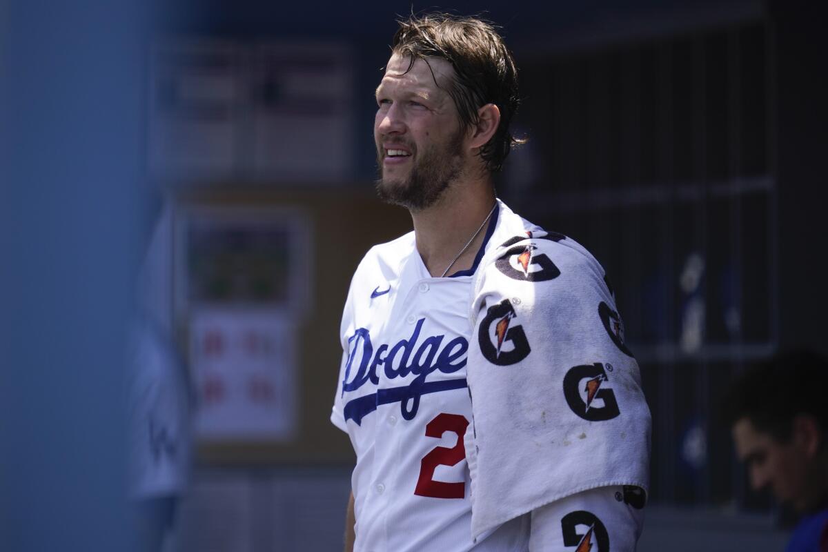Dodgers starting pitcher Clayton Kershaw ices his left arm in the dugout during Sunday's loss to the Giants.
