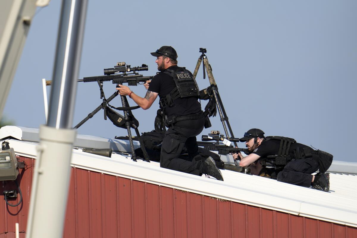 Police snipers return fire after shots were fired while former President Trump was speaking at a rally in Butler, Pa.