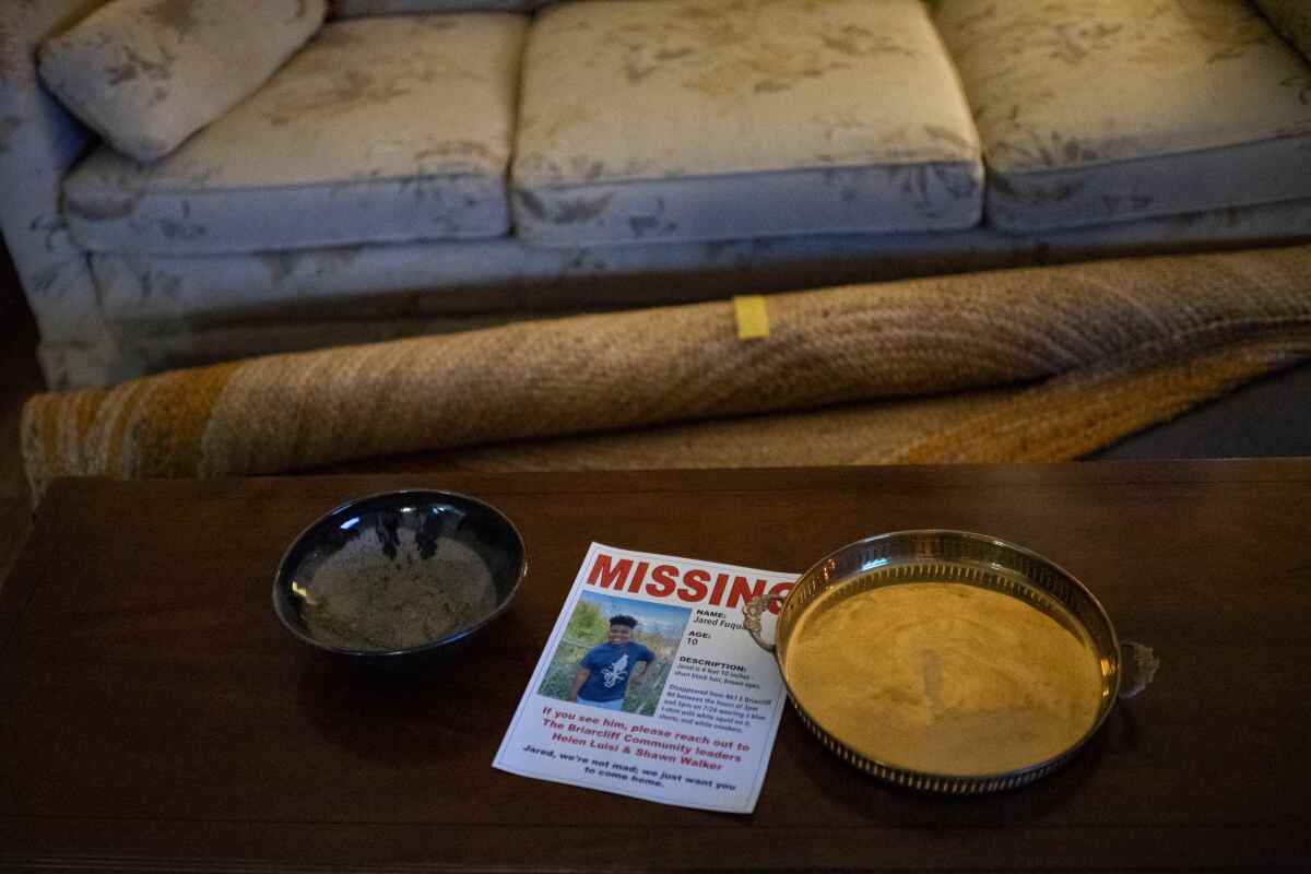 A poster for a missing child sits on a table.