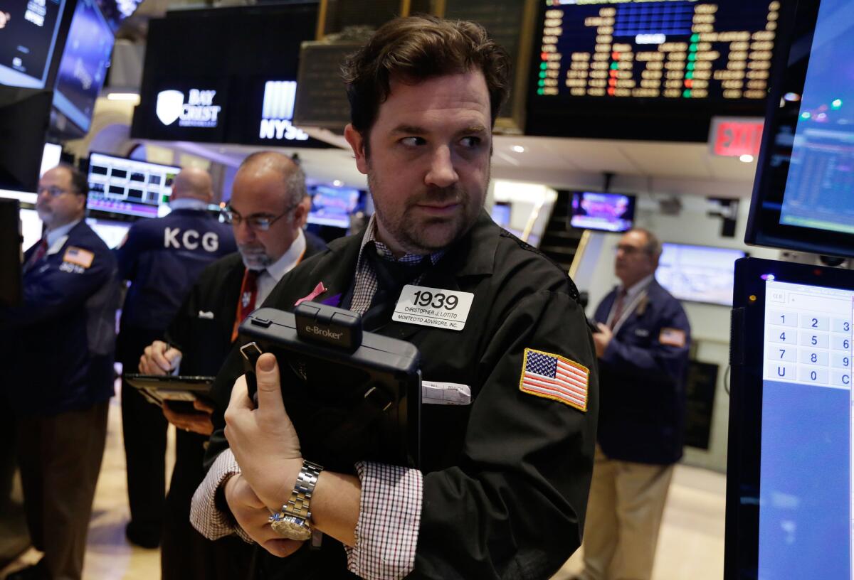 Trader Christopher Lotito on the floor of the New York Stock Exchange, where stocks fell sharply on drop in oil prices.