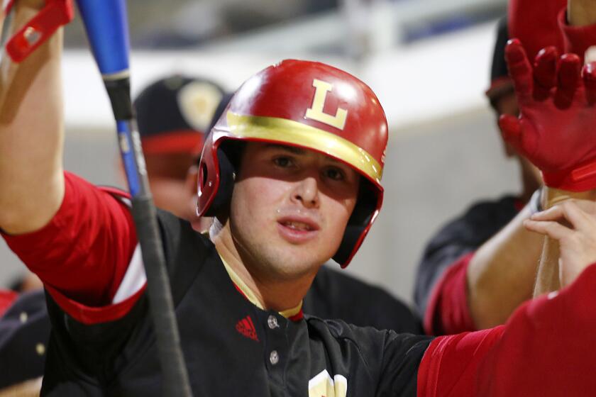 IRVINE, CALIF. - FEB. 19, 2020. Orange Lutheran starter Max Rajcic celebrates after scoring a run against La Mirada during a 2-0 victory at the Great Park Baseball Stadium in Irvine on Wednesday, Feb. 19, 2020. (Luis Sinco/Los Angeles Times)