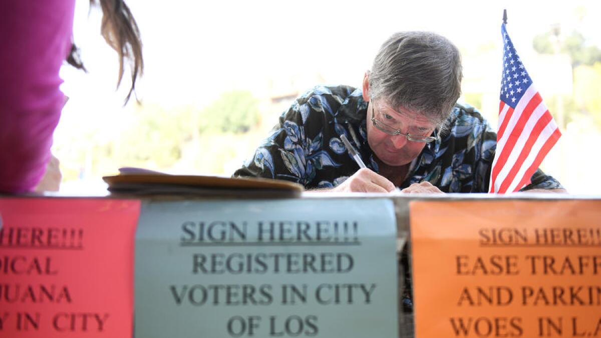 Tim Ecker collects signatures outside a grocery store in Silver Lake on Aug. 9, 2016.