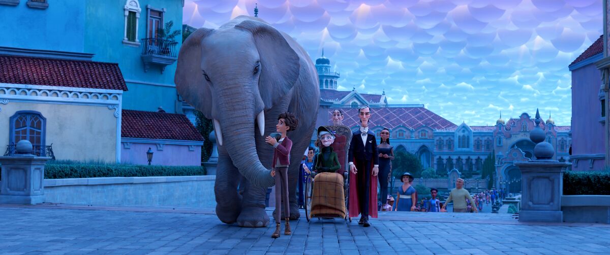 A boy and his family walk through a town square with an elephant.