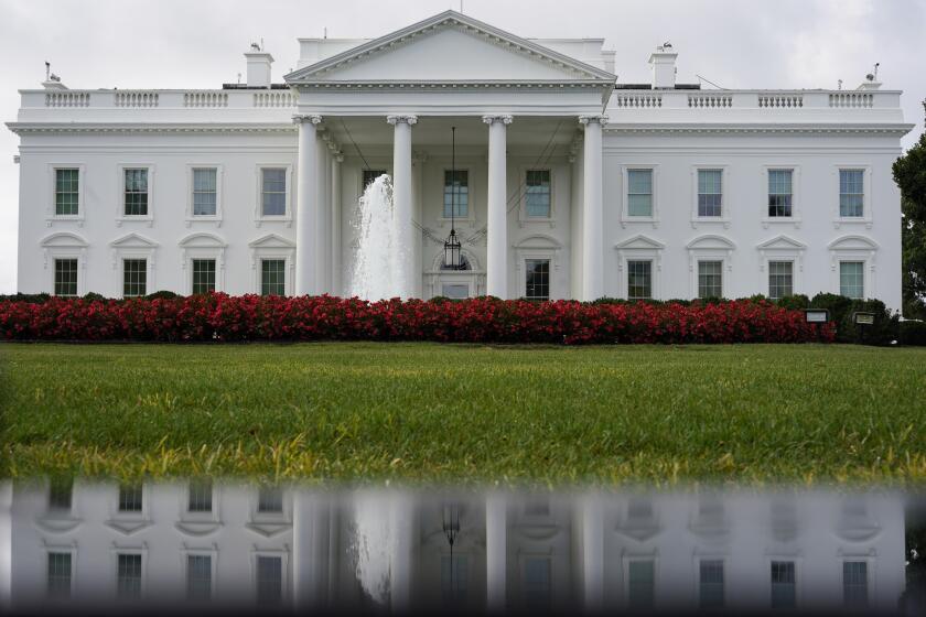 FILE - The White House is seen reflected in a puddle, Sept. 3, 2022, in Washington. The U.S. Senate confirmed Todd Gee on Friday, Sept. 29, 2023, to be the U.S. Attorney for the Southern District of Mississippi, putting him in charge of prosecuting the largest public corruption scandal in state history. (AP Photo/Carolyn Kaster, File)