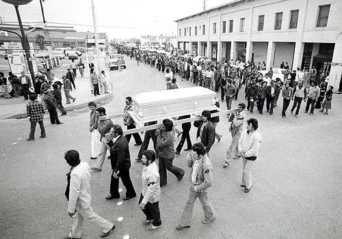 Pallbearers carry Rufino Contreras' casket through Calexico, Calif., on Feb. 14, 1979, leading a crowd of 7,000 mourners who walked three miles to the cemetery. Contreras had been gunned down four days earlier when he and others went into the fields to try to persuade strike-breakers to stop working.