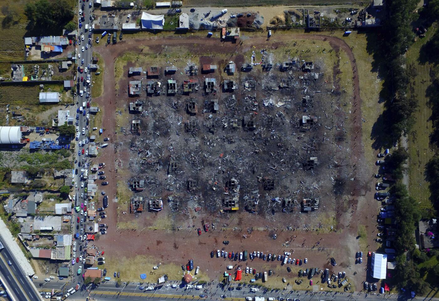 A fireworks market lays in ruins one day after an explosion at the San Pablito Market in Tultepec on the outskirts of Mexico City, Wednesday, Dec. 21, 2016. The market was especially well stocked for the holidays and bustling with hundreds of shoppers when a powerful chain-reaction explosion ripped through its stalls Tuesday, killing and injuring dozens.