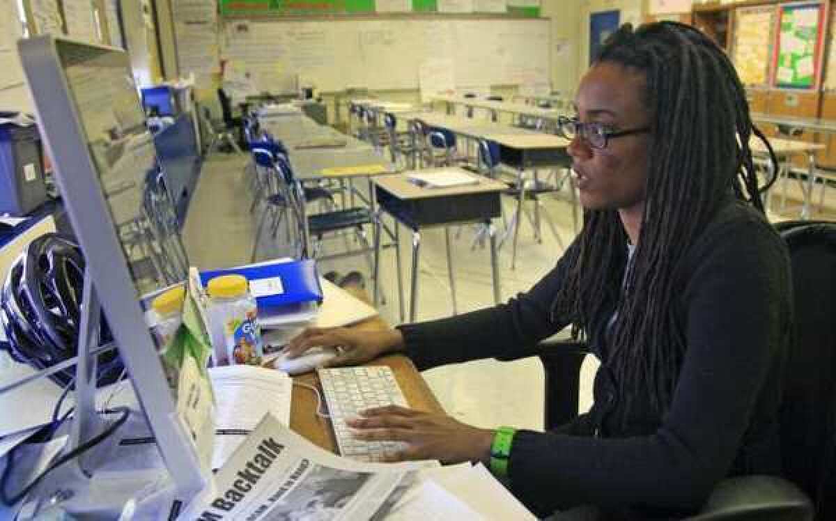 Nkomo Morris, a teacher at Brooklyn's Art and Media High School, works on her classroom computer last month in New York. Morris, who teaches English and journalism, said she has about 50 current and former students as Facebook friends.