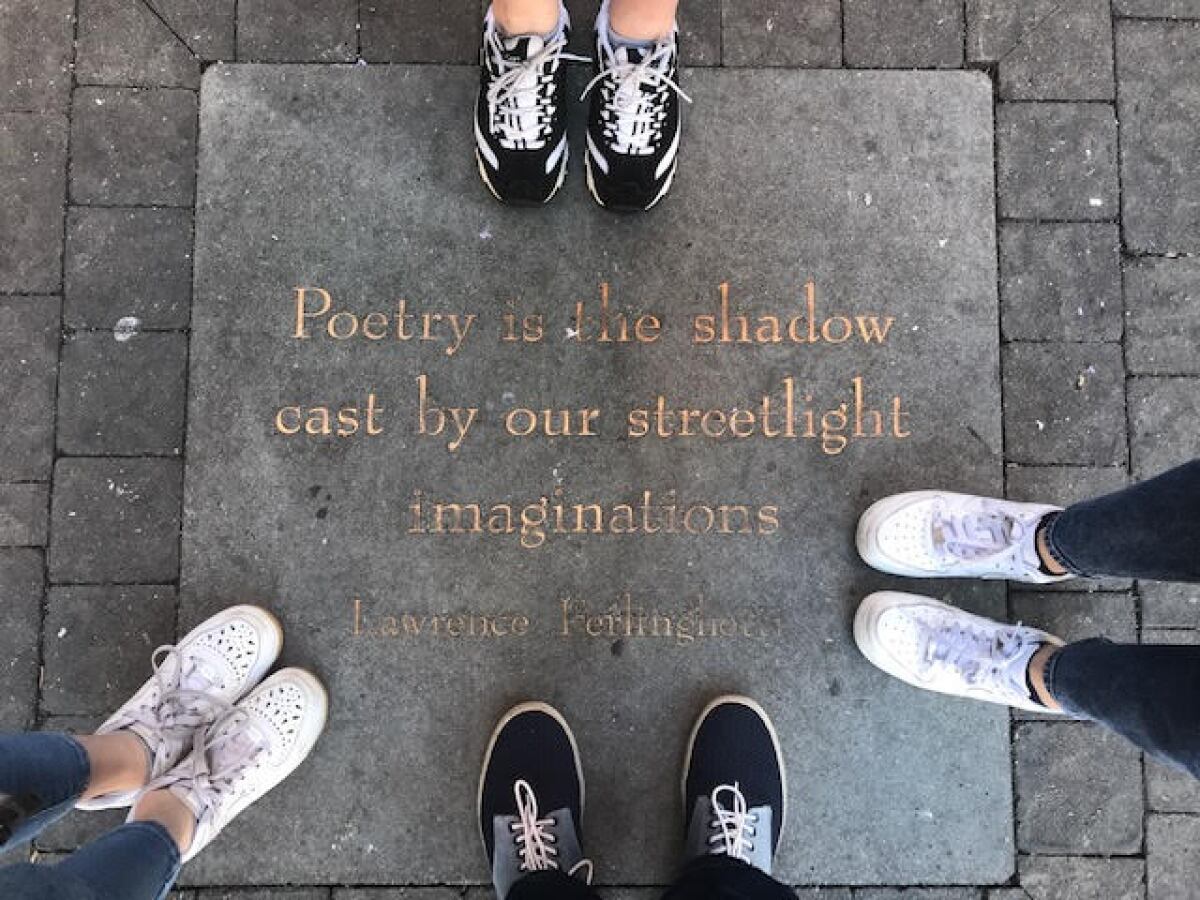 A family poses outside City Lights Bookstore in San Francisco on Jan. 2, 2020.