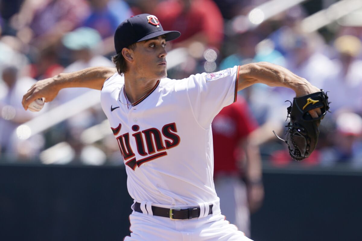 Minnesota Twins pitcher Joe Ryan delivers in the first inning during a spring training baseball game against the Boston Red Sox at Hammond Stadium Sunday, March 27, 2022, in Fort Myers, Fla. (AP Photo/Steve Helber)